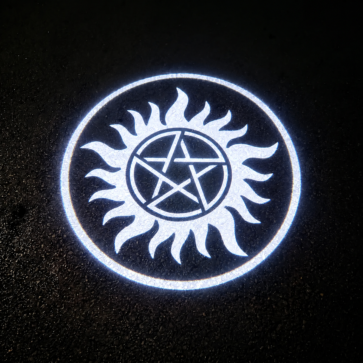 Supernatural white logo projected on asphalt