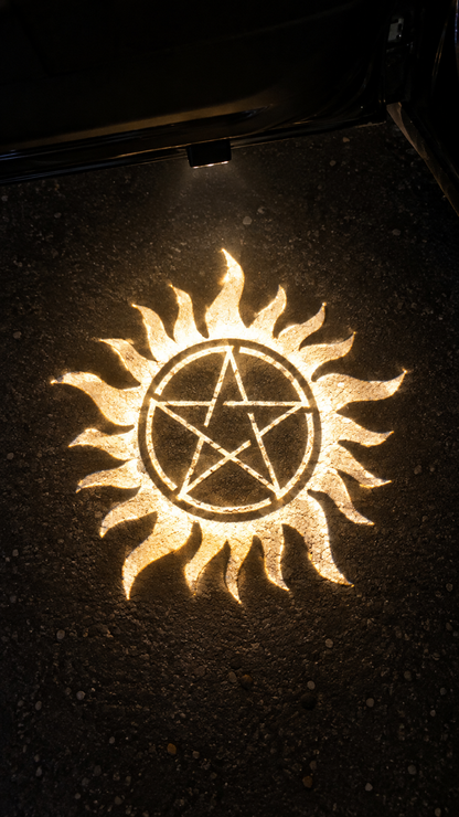 Supernatural yellow logo projected on asphalt